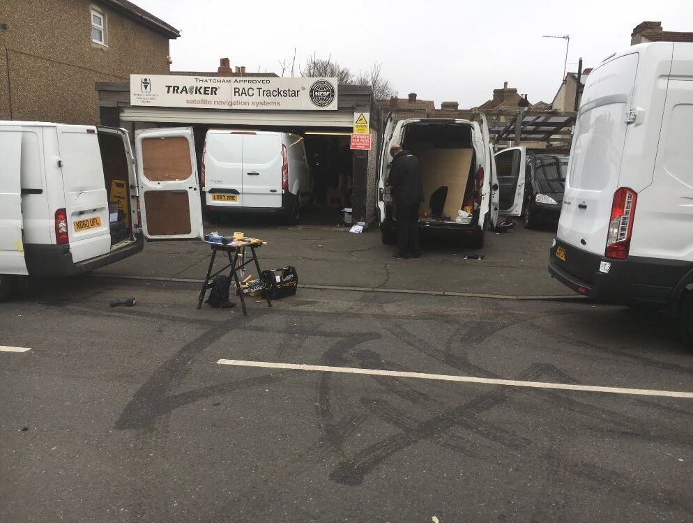 Rear view of the workshop area at the Welling premises, various security precaution jobs being carried out for van drivers